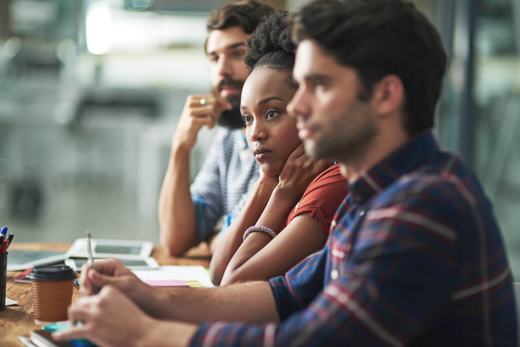 A business team having a meeting to discuss whether they need digital marketing outsourcing services. 