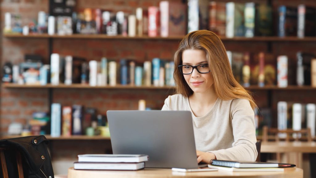 Young girl writing a blog, which is a type of inbound lead generation method.