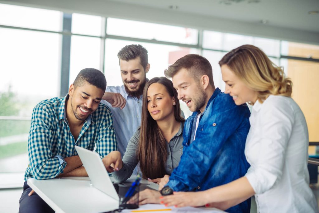 A startup team receiving help in their marketing efforts via a startup marketing consultant.