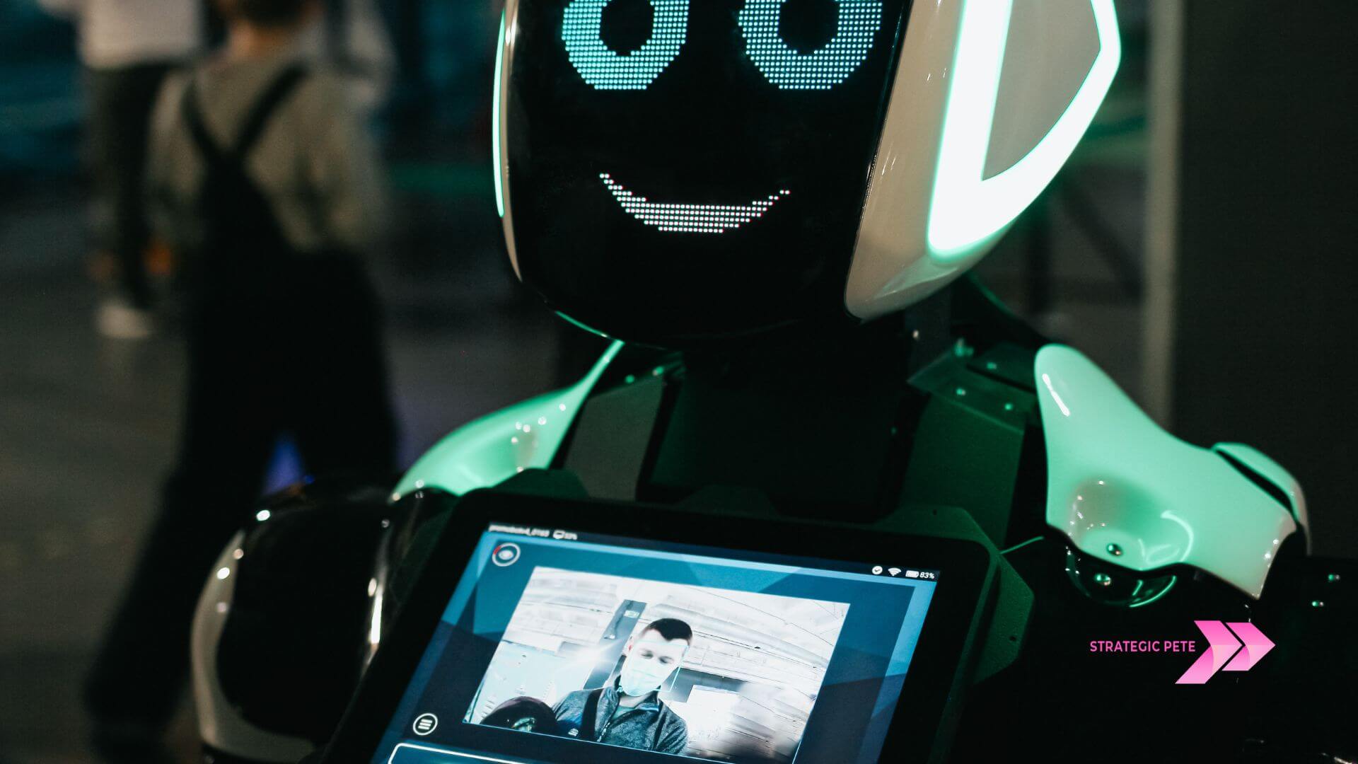 A humanoid robot holding a screen in an office