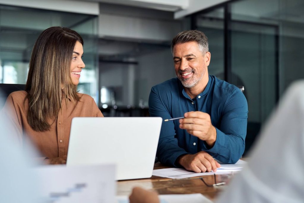 Two people, a man and a woman, discussing the details of a fractional CMO salary.