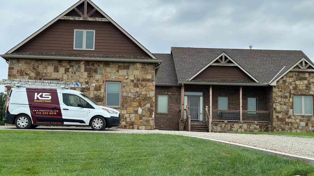 A painting contractor's van parked outside a suburban home