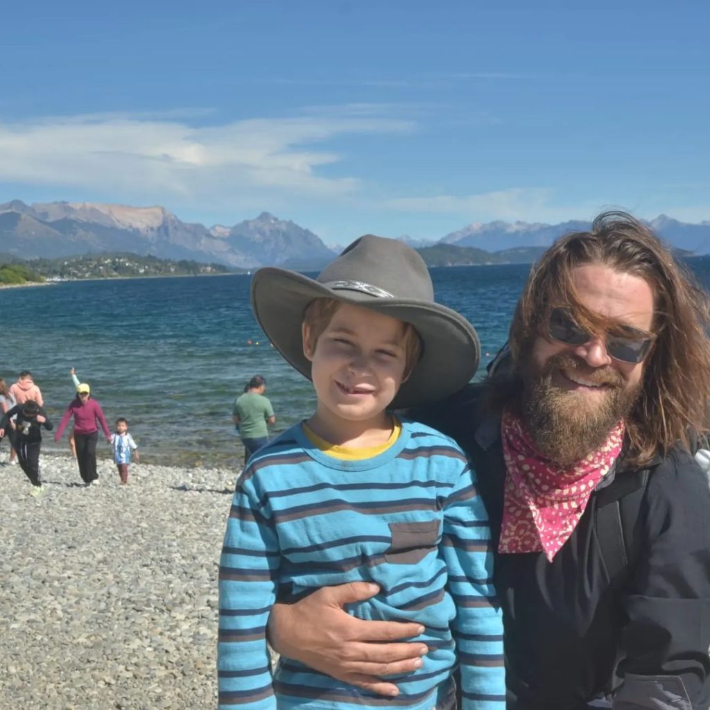 A father and son beside a lake on a family trip