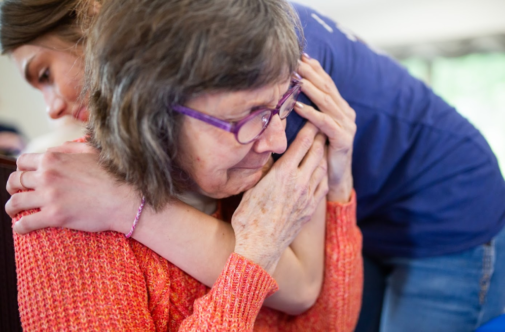 A caregiver comforting a resident