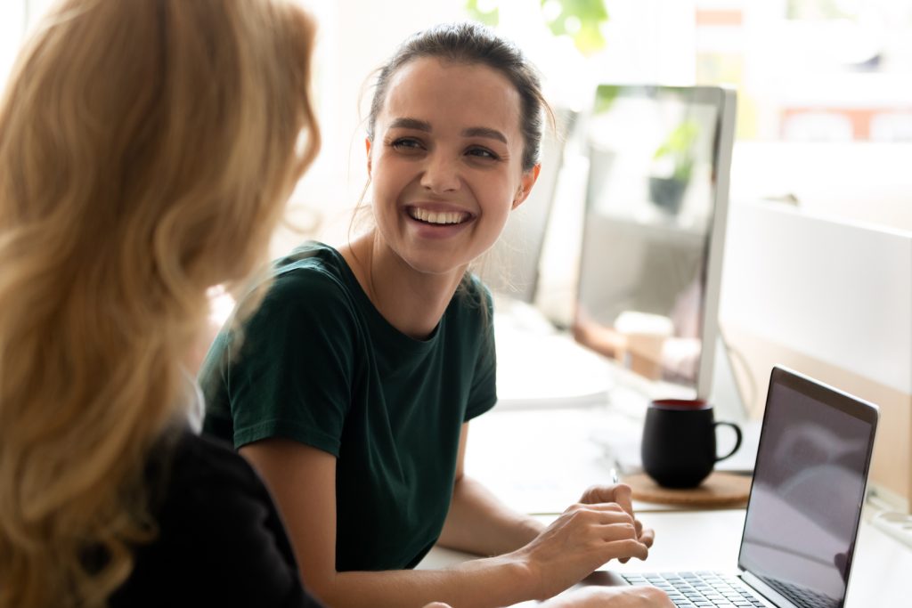 Two colleagues discussing DIY Marketing strategies for their business.