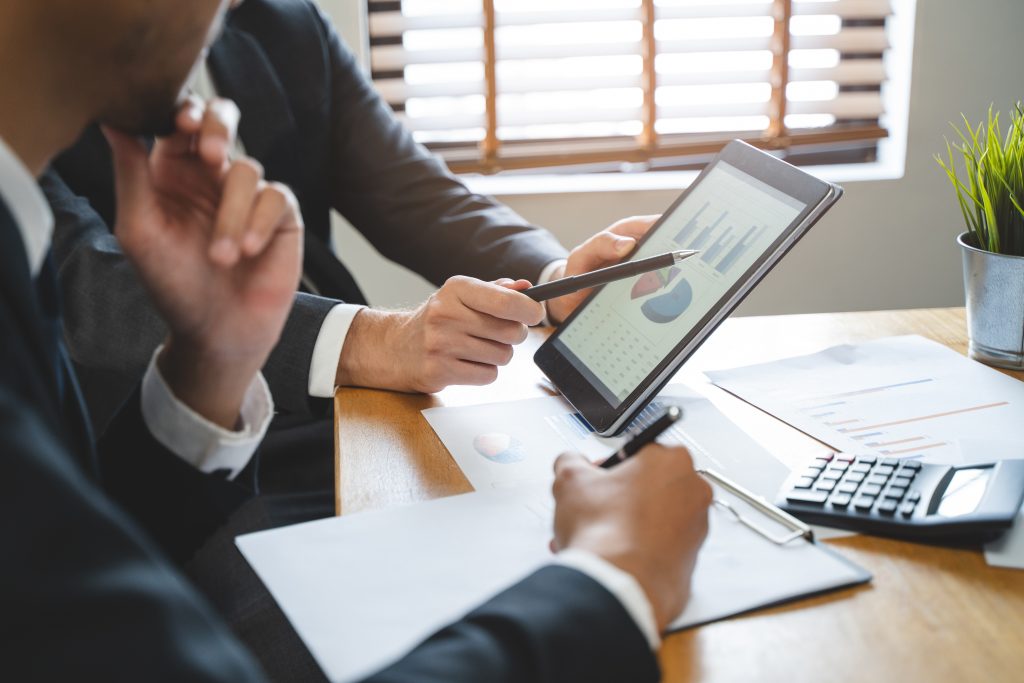 Professionals analyzing financial data for financial services advertising campaigns.