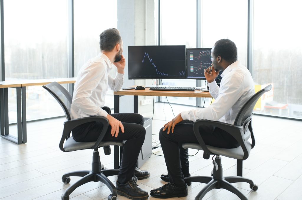Two financial professionals reviewing data for advertising for financial services.