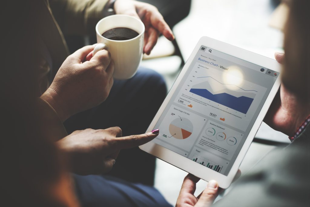 Viewing digital marketing strategy consultants discussing analytics on a tablet screen.