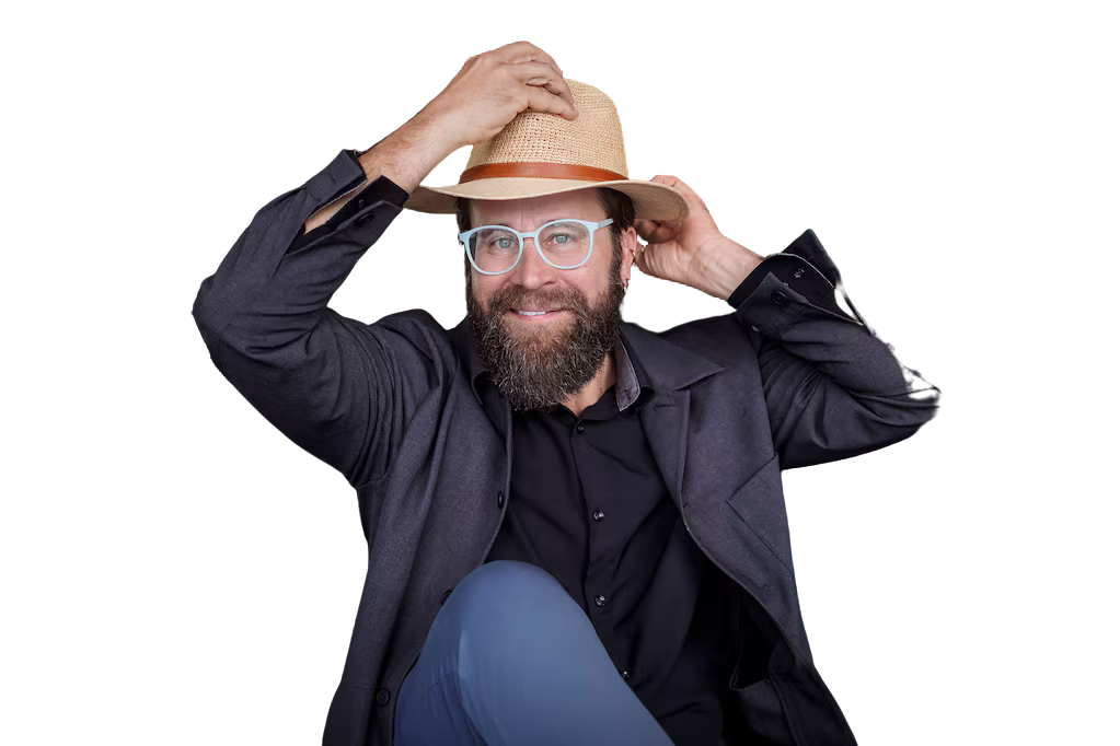 Peter Murphy Lewis, host of Sueno Americano, putting on a straw hat