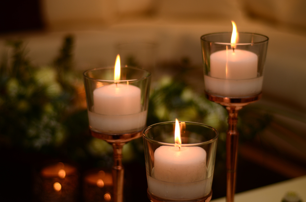 Elegant candles arranged in a peaceful setting, representing remembrance and tranquility, perfect for funeral home marketing materials that emphasize a comforting and serene atmosphere for families in need of services.