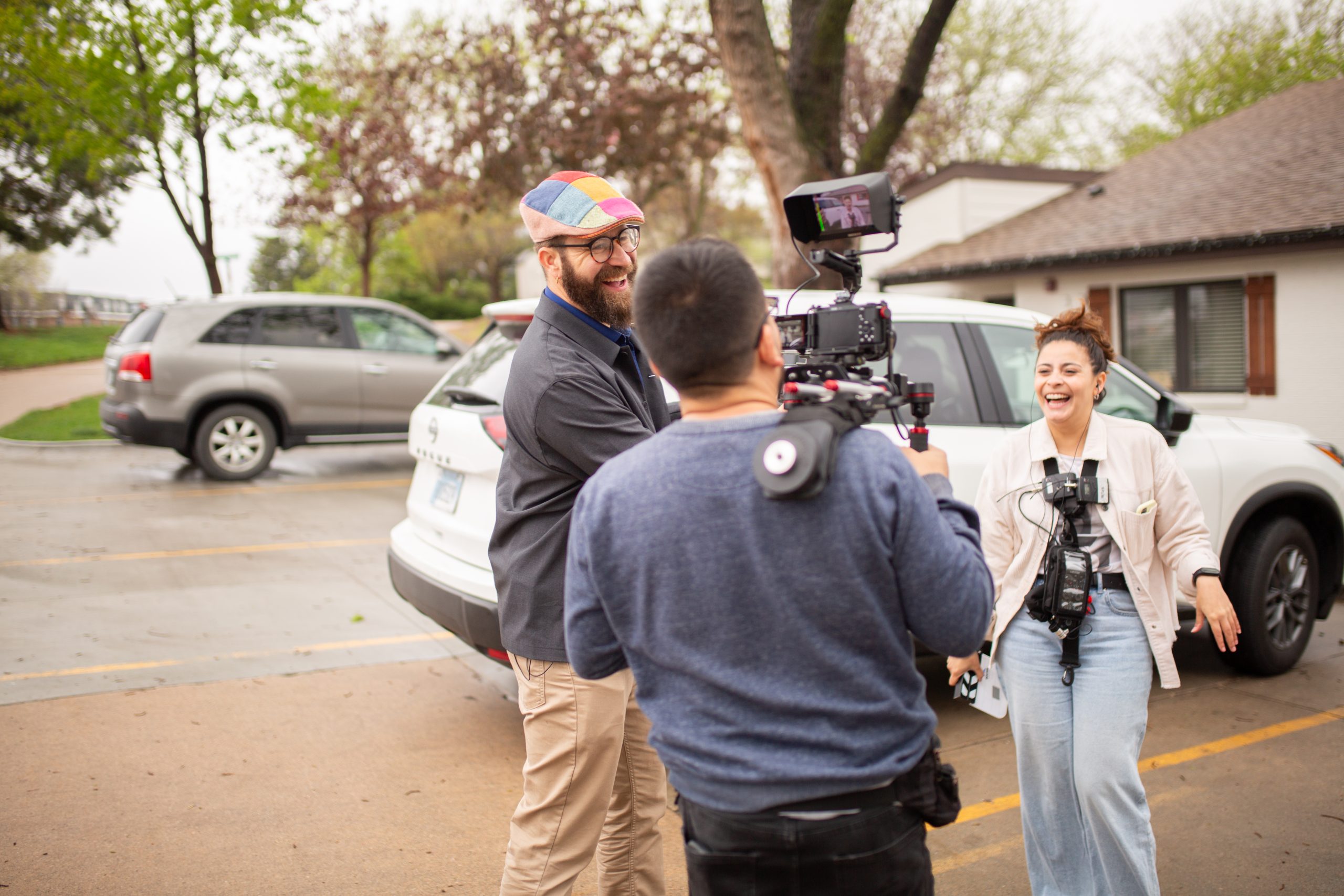 A two-person documentary crew films an interview subject on location