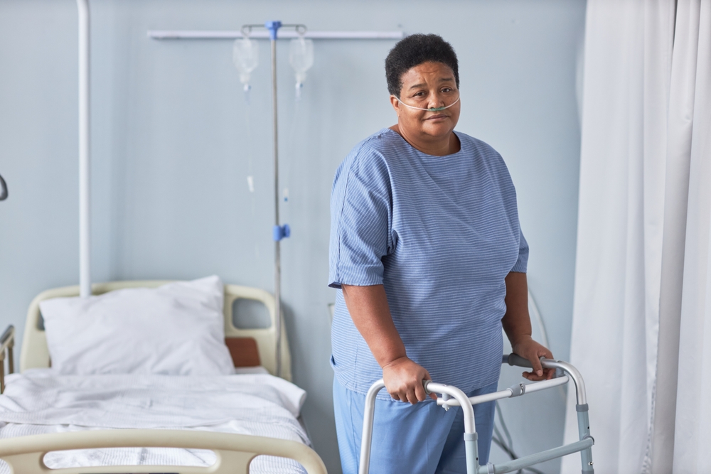 Hospital patient using a walker during recovery, illustrating the real patient experience at the center of marketing healthcare services.