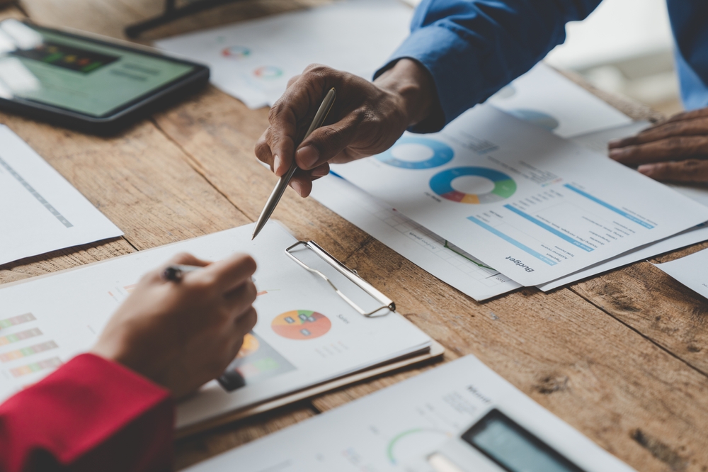 Business professionals reviewing charts and performance data while developing a B2B marketing plan.