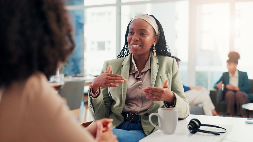 Two professionals discussing ideas in an office setting, representing collaborative storytelling for business and workplace communication.