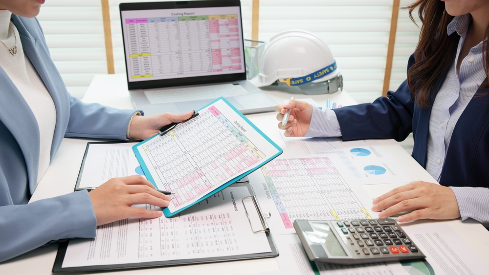 Business professionals reviewing budgets, reports, and performance data during a planning meeting, illustrating marketing for construction companies.