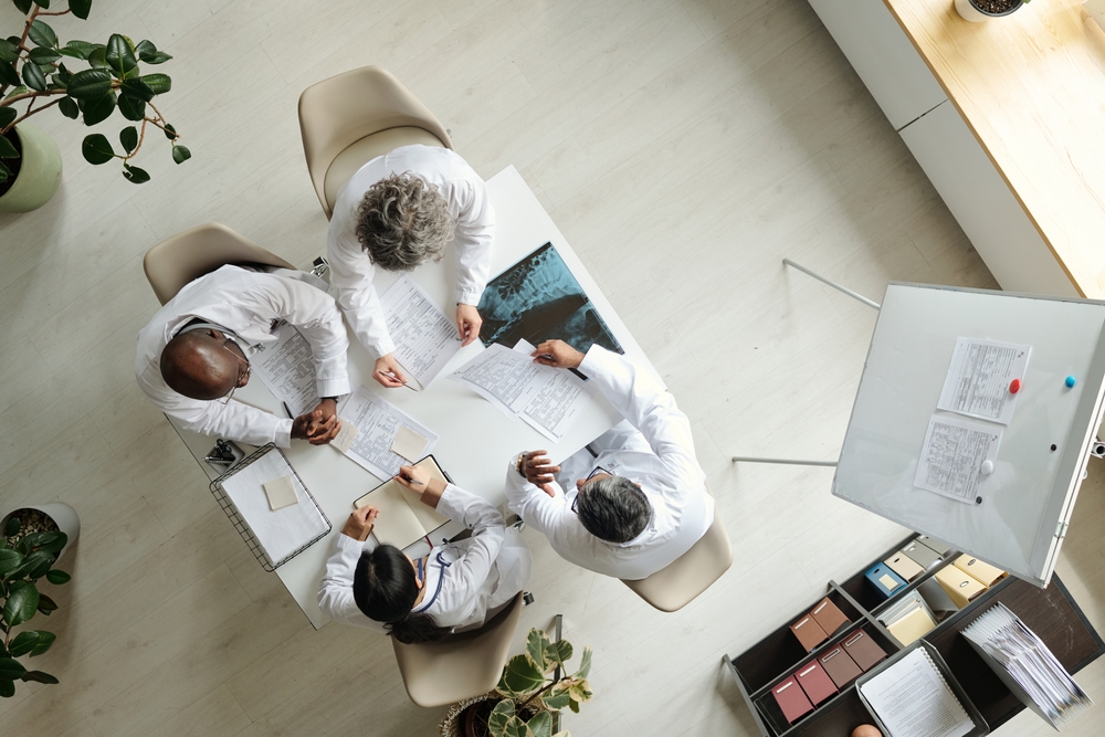 Healthcare professionals collaborating around patient records, illustrating corporate storytelling examples built around real teams, people, and day-to-day work.