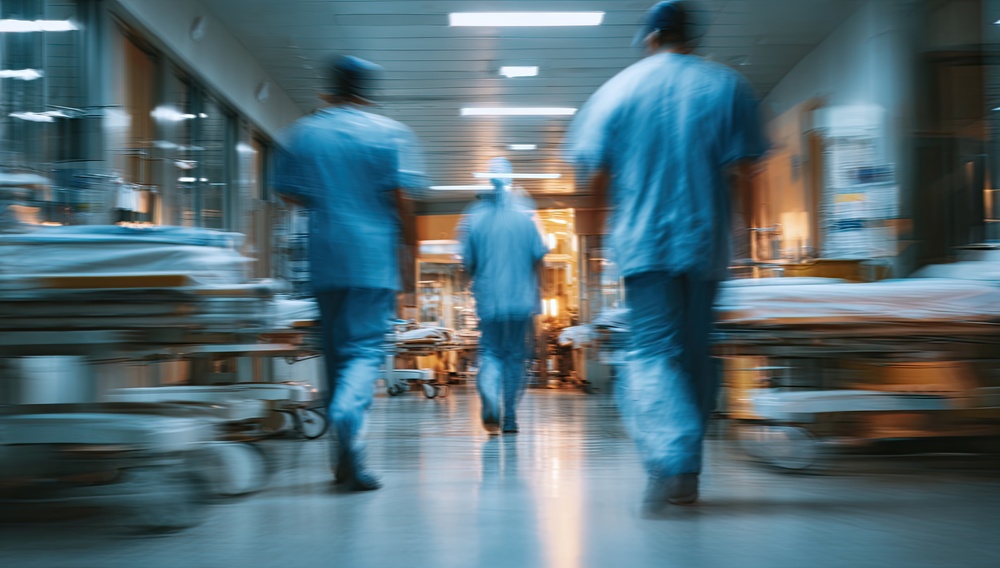 Healthcare professionals moving through a busy hospital corridor, illustrating digital marketing for healthcare and the fast-paced clinical environment.