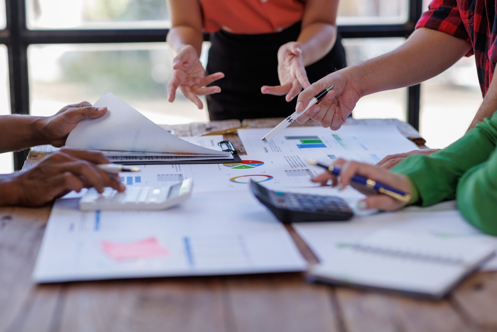 Team reviewing charts and performance data while planning a B2B content marketing strategy.